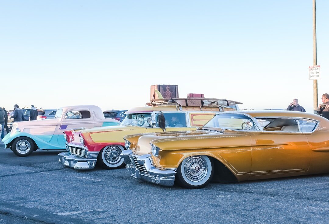Row of classic automobiles from different decades parked together