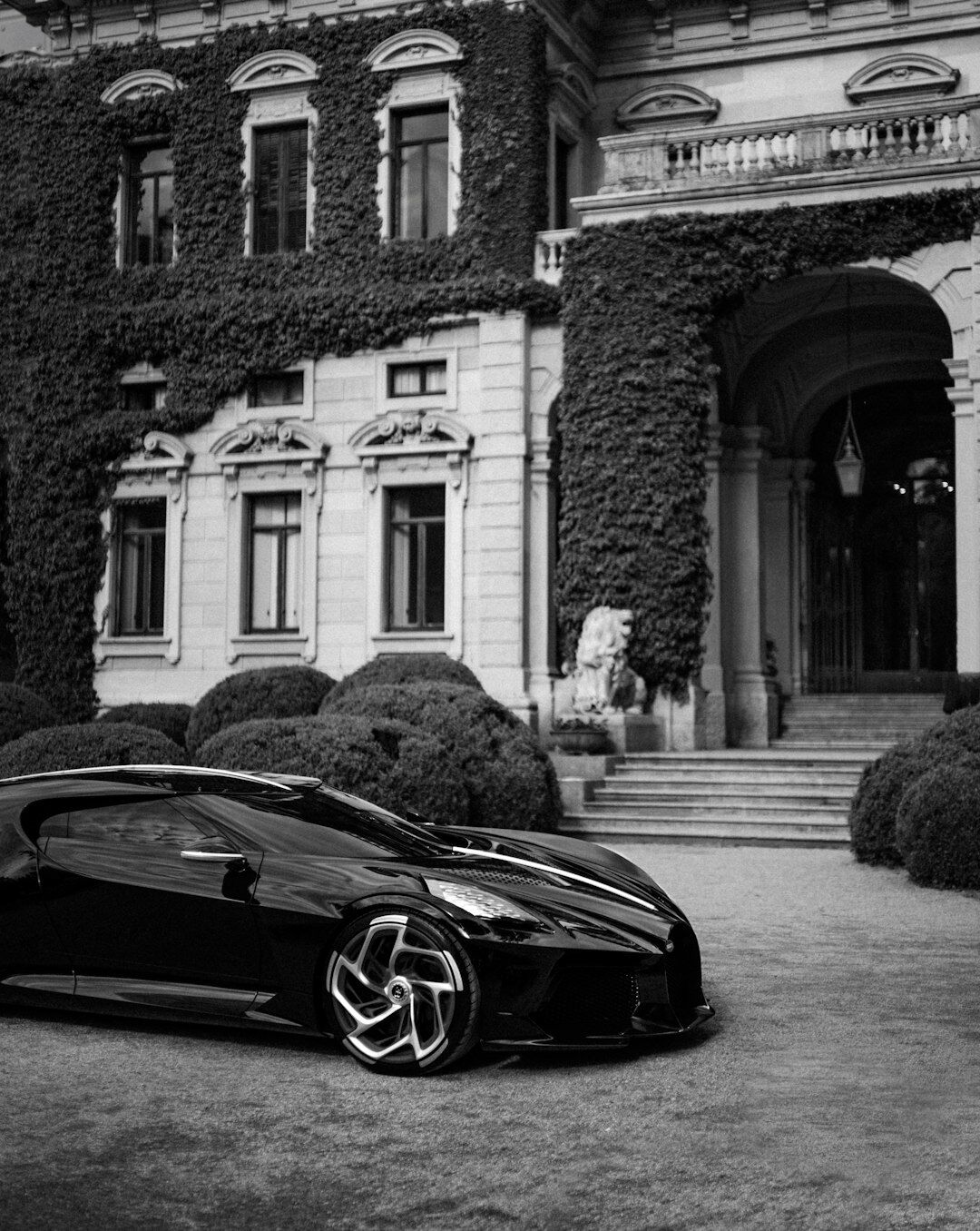 Modern Bugatti hypercar parked in front of a Punta del Este beach house