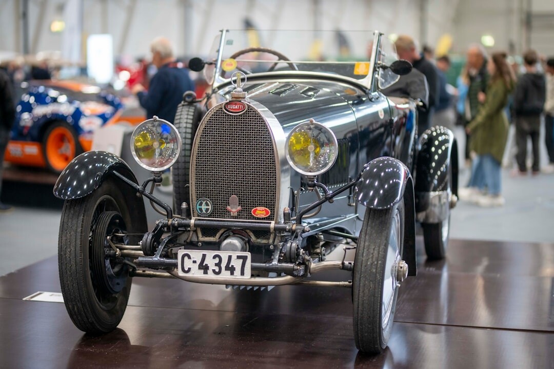 Rare vintage Bugatti automobile displayed at a formal auction hall