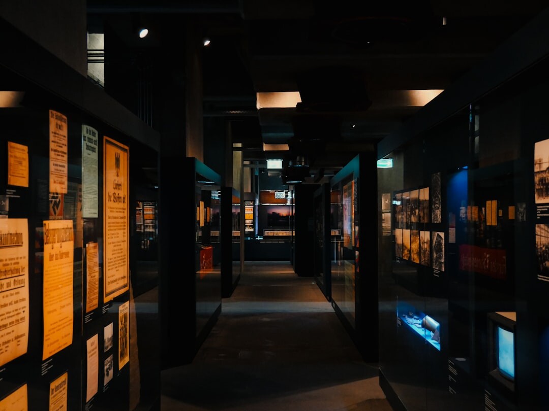 Modern exhibition hall displaying hypercars under dramatic lighting