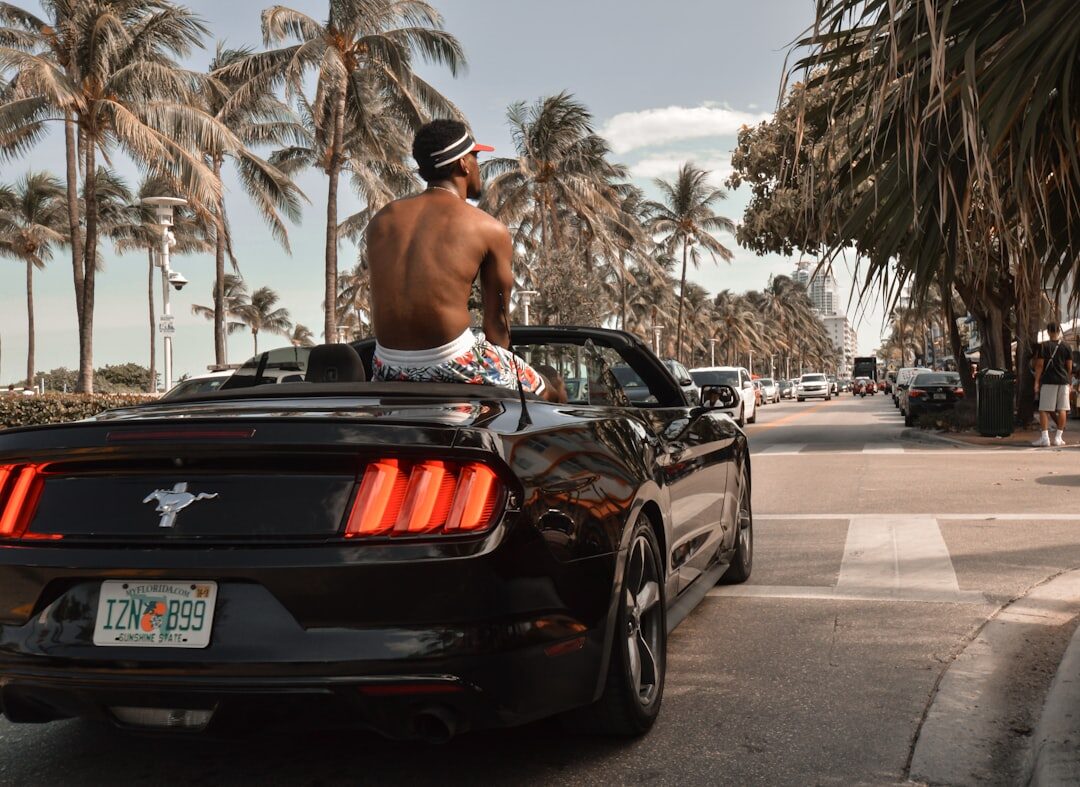 Luxury convertible automobile parked on a sandy beach road in Punta del Este