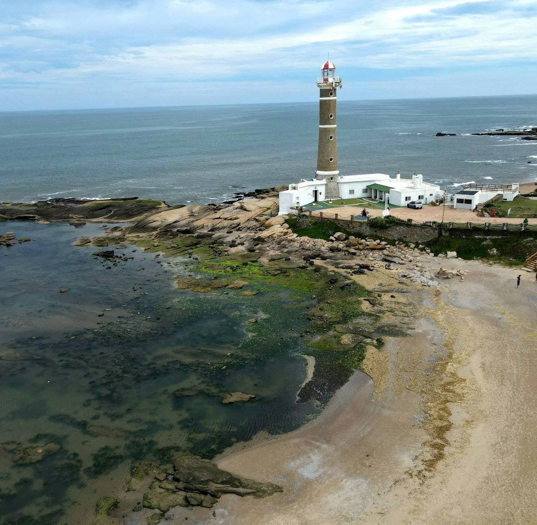 Classic automobile parked near a lighthouse in Jose Ignacio, Uruguay
