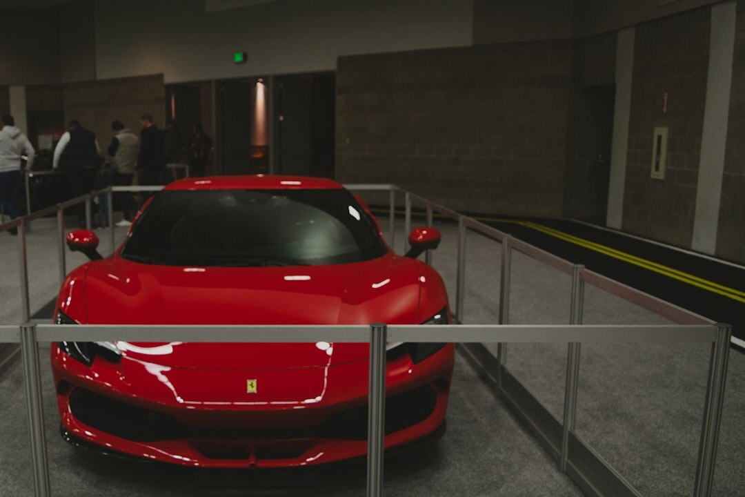 Vintage Ferrari displayed at an elegant auction event indoors
